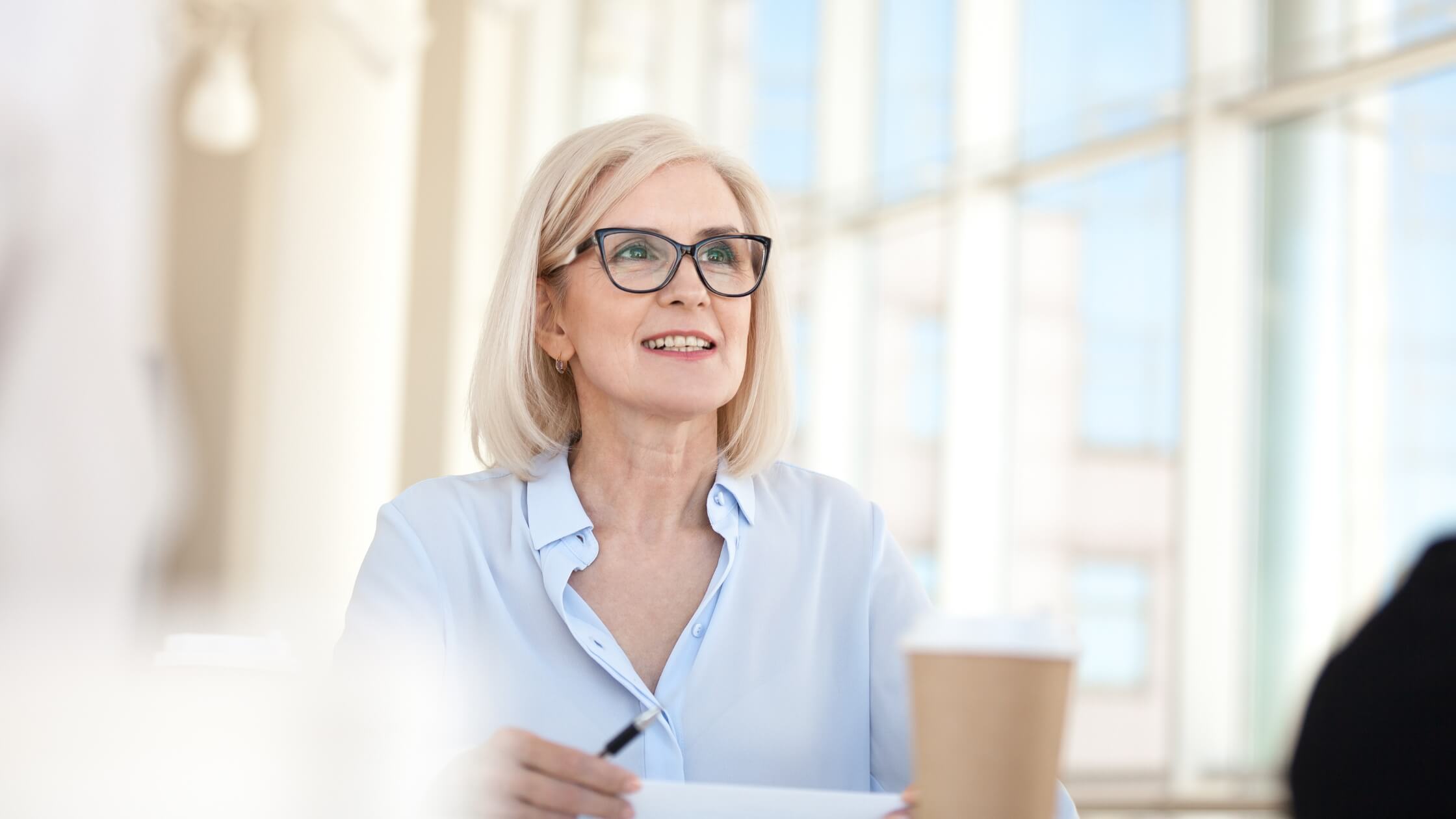 Confident businesswoman smiling during a meeting, representing strategies to generate leads with social media