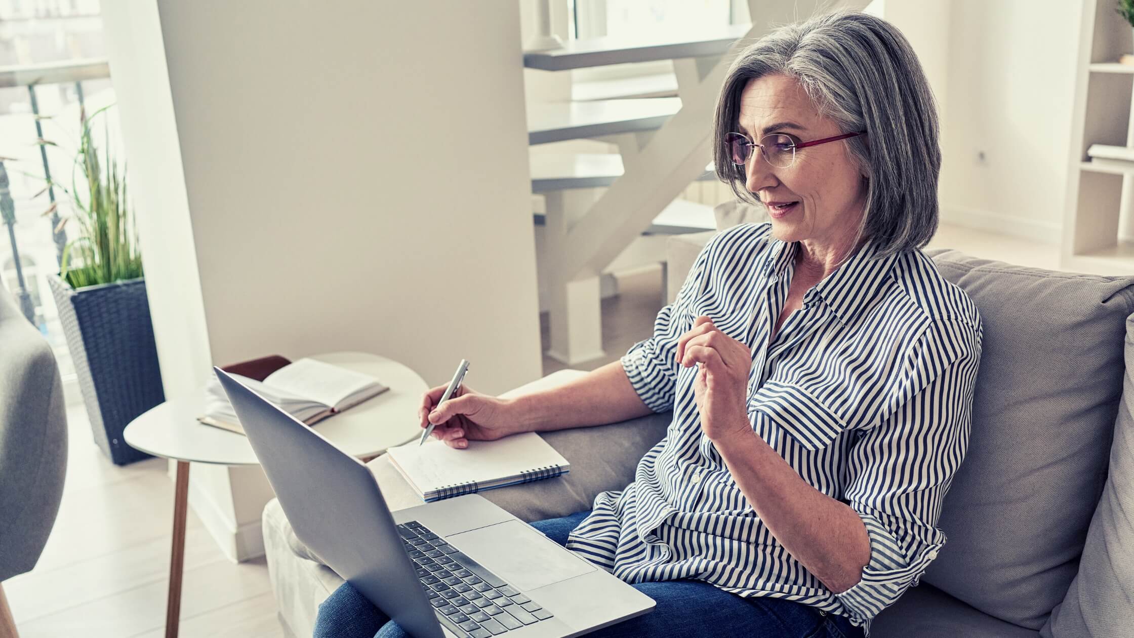 mature-woman-working-marketing-for-coaches Confident coach working online with laptop and notebook, learning strategies for effective marketing for coaches