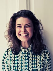 Smiling woman looking satisfied with Delegate First bookkeeping services, reflecting trust and professionalism