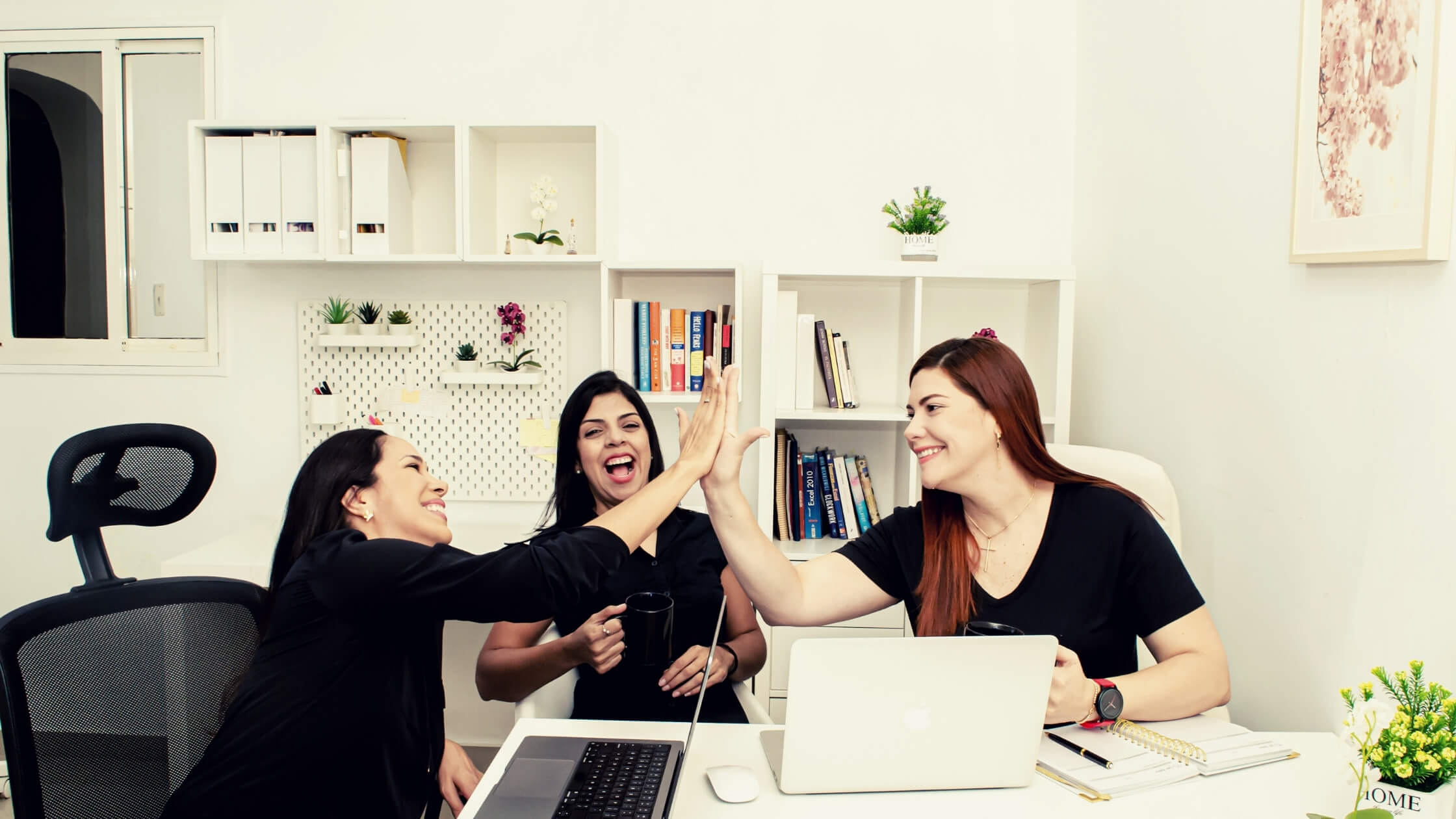 Delegate First monthly bookkeeping team Delegate First bookkeeping team collaborating in the office to provide reliable monthly bookkeeping services for service-based businesses